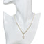 A gold paperclip chain with pearls and a pearl pendant drop.