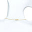 A gold paperclip chain with pearls and a pearl pendant drop.