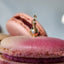 Gold earring with a diamond on a pink macaron