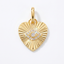 A gold heart-shaped pendant with a sunburst ribbed design and a central eye motif paved with small clear stones, shown on a clean white background.