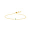 A dainty adjustable chain bracelet with a single bezel set gemstone