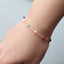 Bracelet with colorful beads on a wrist against a light background