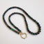 A bubble opal beaded necklace with two round loops at the ends. Available in black and white rounded smooth beads. 