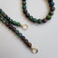 A bubble opal beaded necklace with two round loops at the ends. Available in black and white rounded smooth beads. 