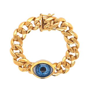 A chunky curb chain bracelet with a realistic blue eye set in bezel setting in the center. 