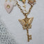 Close-up of a person wearing multiple gold necklaces with various pendants.