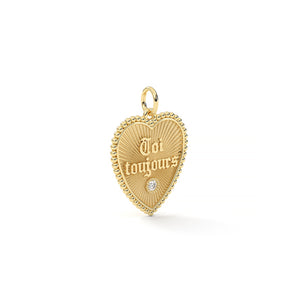 Gold heart-shaped pendant with 'Toi toujours' engraving on a white background