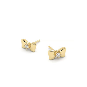 Gold bow-shaped earrings with clear gemstones on a white background