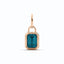 A vivid blue emerald cut diamond bezel set with ribbed edges. With jump ring bail. Available in yellow, rose, and white gold. 