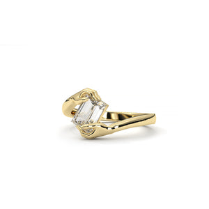 Gold ring with a clear gemstone on a white background