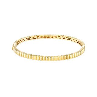 A gold bangle bracelet with ribbed square pattern. Very classic and looks best stacked. 
