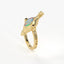 Gold ring with a colorful gemstone on a white background