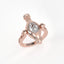 Rose gold ring with a diamond on a white background