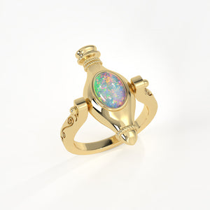 Gold ring with an opal stone on a white background