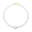 A faceted ombre beaded necklace with a large oval pearl in the center with two accent beads and round clasp. 