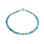 A bright colored opal beaded bracelet with solid gold beaded accents and round clasp. 