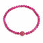 Pink beaded bracelet with a gold accent on a white background