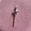 a magic wand with a white gold star and yellow gold and diamond handle