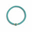 Turquoise beaded bracelet with a gold accent on a white background