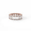 Rose gold ring with emerald-cut diamonds on a white background