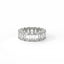 Diamond ring with emerald-cut stones on a white background