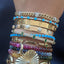 A chain bracelet with round turquoise cabochon stationed between diamond bars. Secure push lock with two figure eight safety locks. 