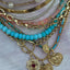 A gold connector that is designed to look like a snake eating it's tail. The sneak head has gemstone or diamond eyes and the tail clicks into the head for closure. 