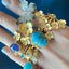 The four pedal flower ring stacked with other similar styles.
