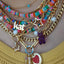 A hand carved gemstone gummy bear pendant offering four colors. three dimensional. 