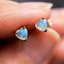 A pair of cute opal heart earrings. The opals are white with pink and blue flash. Made in solid gold. 