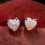 A pair of cute opal heart earrings. The opals are white with pink and blue flash. Made in solid gold. 