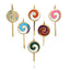 A gold lollipop charm with colored gemstone in lay. The head of the lollypop has a swirl pattern where the stone in lay is set. 