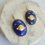 Solid gold Saturn pendant with stars set in lapis stone. The Saturn is set inside the lapis creating a flushed look. 