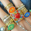 A Italian mosaic evil eye ring with ombre pattern and a round carnelian set in the middle.