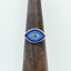 This product picture is showing the blue mosaic pixel ring. This ring is eye shape and consists of 20 different shades with a blue sapphire center. 