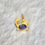 A yellow gold cat pendant with orange fire opal oval cabochon set at the belly. The cat has two diamond eyes and gold whisker and tail. 