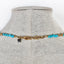 A blue turquoise necklace with turquoise nugget beads and gold nugget bead accents. Finished with lobster clasp. 