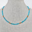 A blue turquoise necklace with turquoise nugget beads and gold nugget bead accents. Finished with lobster clasp. 
