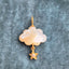 A storm cloud pendant with a hand carved gemstone and a solid gold charm attached at the bottom of the cloud.