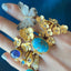 A large oval blue turquoise stone bezel set in gold vermeil. On the side it has a diamond shaker to add uniqueness to the design. Simple tube band. 