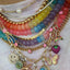A cable chain necklace with five bright colored stars dangling on the chain. Finished with lobster clasp.